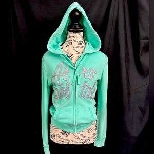Aeropostale light turquoise women’s hoody. Sequins appliqué on front. Size SP.